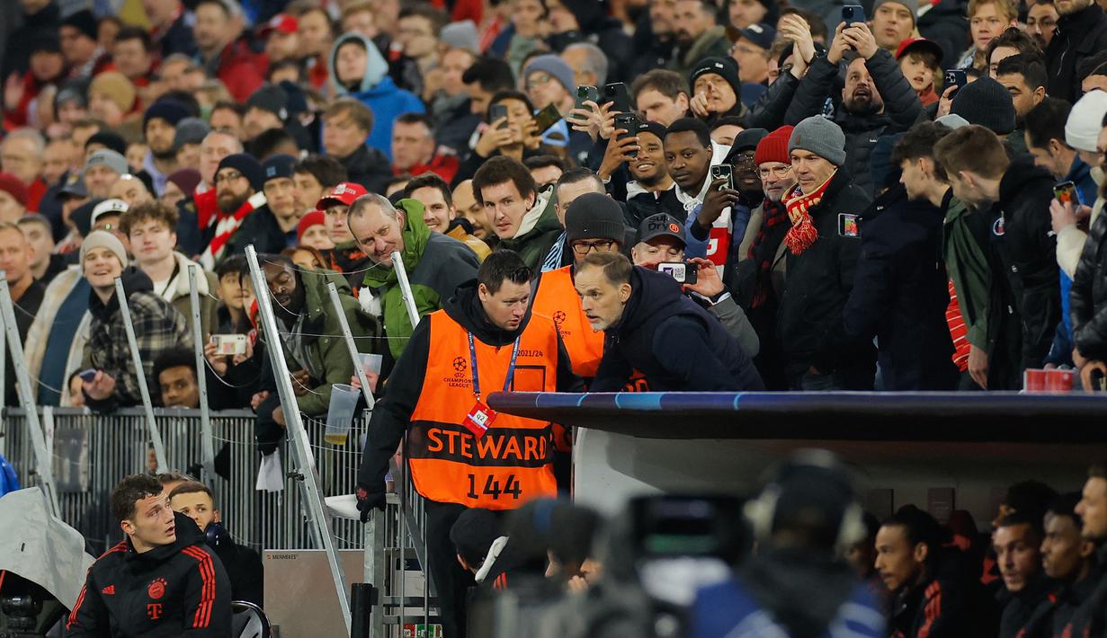 Pelatih Bayern Munchen, Thomas Tuchel, mengamati permainan anak asuhnya dari tribun penonton setelah diusir wasit saat melawan Manchester City pada babak perempat final leg kedua Liga Champions di Allianz Arena, Kamis (20/4/2023). (AFP/Odd Andersen)