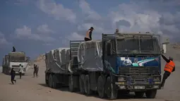 Bantuan ini akan diangkut oleh Perserikatan Bangsa Bangsa dan organisasi internasional setelah pemeriksaan keamanan ketat oleh otoritas Israel. Tampak dalam foto, truk-truk yang mengangkut bantuan kemanusiaan melintasi Kota Gaza setelah masuk dari Israel melalui pos perbatasan Zikim di bagian utara Jalur Gaza, Kamis 13 November 2025. (AP Photo/Jehad Alshrafi)