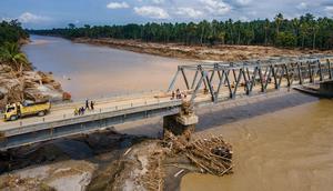 Jembatan bailey merupakan jenis jembatan portabel pracetak yang terbuat dari baja. Tampak foto udara menunjukkan jembatan yang baru dibangun yang menghubungkan Aceh dan provinsi Sumatera Utara di sungai Peusangan di kabupaten Bireuen, provinsi Aceh, pada Selasa 9 Desember 2025. (CHAIDEER MAHYUDDIN/AFP)