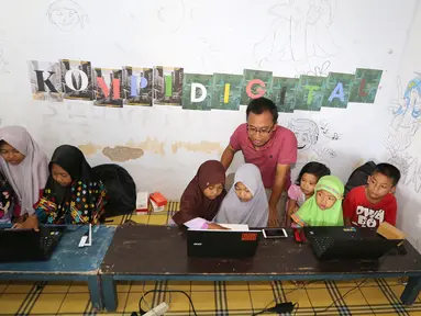 Penggagas Kebumen Desa Digital, Wahyu Yoga Pratama memberikan pelatihan internet kepada anak-anak, di Desa Tambakprogaten, Kabupaten Kebumen, Jawa Tengah, Minggu (6/5). (Liputan6.com/Fery Pradolo)