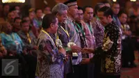 Presiden Jokowi (kanan) ketika memberikan piala anugerah Tim Pengendalian Inflasi Daerah (TPID) pada daerah yang terpilih dalam acara pembukaan Rakornas ke-7 TPID Tahun 2016 di Jakarta, Kamis (4/8). (Liputan6.com/Faizal Fanani)