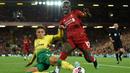Gelandang Liverpool, Sadio Mane, berusaha melewati bek Norwich, Max Aarons, pada laga Premier League di Stadion Anfield, Liverpool, Jumat (9/8). Liverpool menang 4-1 atas Norwich. (AFP/Oli Scarff)