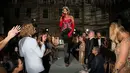 Rihanna menari di atas meja. Pada Met Gala 2015, Rihanna dengan gaun dari Guo Peinya membuka acara dengan pertunjukan luar biasa, yaitu menyanyikan "Bitch Better Have My Money" di atas meja makan. Foto: Vogue.