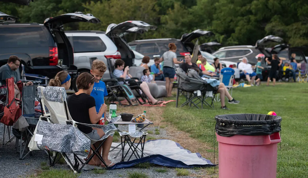 Orang-orang menghadiri pemutaran film drive-in di Union Market, Washington, 3 Agustus 2018. Menonton film di luar ruangan atau drive-in merupakan bagian penting dalam industri hiburan di Amerika. (AFP PHOTO/Nicholas Kamm)