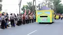 Kereta kencana yang ditumpangi Jokowi dan keluarga, mendapat pengawalan dari Paspampers. Para pengawal itu mengenakan beskab, yang biasa digunakan oleh orang Jawa Pria dalam acara resmi. (Deki Prayoga/Bintang.com)