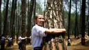 Acara memeluk pohon selama dua menit saat perayaan Hari Lingkungan Hidup Sedunia di Kathmandu, Nepal (5/6/2014) juga ditujukan untuk memecahkan rekor dunia. (REUTERS/Navesh Chitrakar)