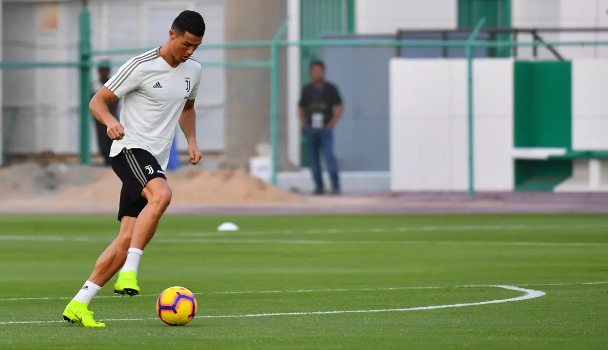 Striker Juventus, Cristiano Ronaldo, menggiring bola saat sesi latihan jelang laga Supercoppa Italia di Stadion King Abdullah Sports City, Selasa (15/1). Juventus akan berhadapan dengan AC Milan. (AFP/Giuseppe Cacace)