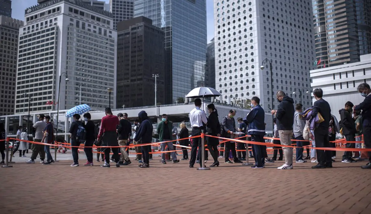 Orang-orang berdiri dalam antrean untuk pengujian virus corona COVID-19 di Hong Kong, 12 Februari 2022. Pihak berwenang bergegas untuk meningkatkan kapasitas pengujian COVID-19 menyusul rekor tertinggi infeksi baru. (Louise Delmotte/AFP)