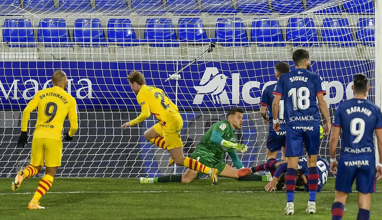 Gelandang Barcelona, Frenkie de Jong, mencetak gol ke gawang Huesca pada laga Liga Spanyol di Stadion El Alcoraz, Minggu (3/1/2021). Barcelona menang tipis dengan skor 1-0. (AP/Alvaro Barrientos)