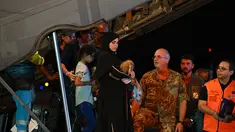 Petugas medis dan tenaga kesehatan menyambut anak-anak Palestina dari Gaza beserta keluarga mereka, setelah pesawat militer Italia C130J dari Israel mendarat pada 14 Agustus 2025 di Bandara Ciampino, Roma. (Andreas SOLARO/AFP)