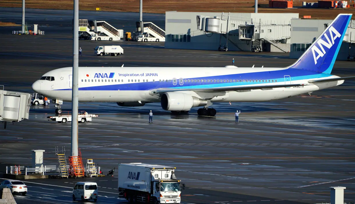 Pesawat charter yang membawa warga Jepang dari Wuhan, China, mendarat di bandara internasional Haneda di Tokyo, Rabu (29/1/2020). Ini merupakan penerbangan gelombang pertama evakuasi warga Jepang dari kota Wuhan, pusat penyebaran virus korona. (AP/Eugene Hoshiko)