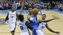 Pebasket San Antonio Spurs, Patty Mills dan Rudy Gay, berusaha menghadang pebasket Oklahoma City Thunder, Russell Westbrook, pada laga NBA di Chesapeake Energy Arena, Minggu (11/3/2018). Thunder menang 104-94 atas Spurs. (AP/Sue Ogrocki)