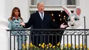 Presiden AS Donald Trump didampingi istirnya Melania Trump dan badut Kelinci Paskah berbicara dari Truman Balcony saat perayaan Easter Egg Roll di Gedung Putih, Washington (4/2). (AP Photo / Carolyn Kaster)