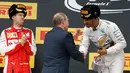Pembalap Formula 1 tim Mercedes, Lewis Hamilton diberi ucapan selamat secara langsung oleh Presiden Russia, Vladimir Putin usai menjuarai ajang balap GP Formula 1 Rusia di Sochi, Minggu (11/10/2015). (REUTERS/Grigory Dukor)