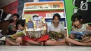 Anak-anak membaca buku di Pojok Baca Kampung Literasi RW 09, Kampung Pondok Jati, Palmeriam, Jakarta Timur, Senin (10/10/2022). Pojok Baca Kampung Literasi dibangun untuk menjadi fasilitas baru bagi anak-anak hingga orang dewasa yang berada di kawasan permukiman padat penduduk tersebut dalam memperkaya literasi dan meningkatkan minat membaca sejak dini. (merdeka.com/Iqbal S. Nugroho)