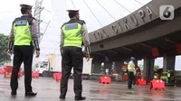 Petugas Kepolisian saat melakukan penyekatan larangan mudik lebaran di gerbang tol Cikupa, Kabupaten Tangerang, Banten, Kamis (6/5/2021). Penyekatan dilakukan seiring telah diberlakukan larangan mudik Lebaran mulai dari 6 hingga 17 Mei 2021.  (Liputan6.com/Angga Yuniar)