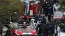 Regu penyelamat berada di lokasi jatuhnya helikopter militer di lingkungan perumahan di Istanbul, Turki, Senin (26/11). Helikopter dalam penerbangan latihan ketika menabrak atap gedung dan jatuh di tengah daerah perumahan Sancaktepe. (AP/Emrah Gurel)