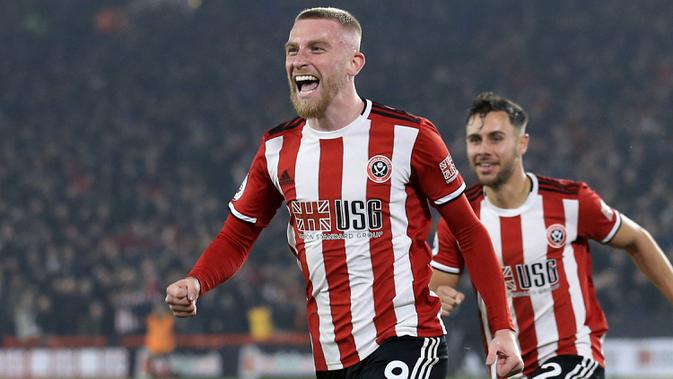 Penyerang Sheffield United, Oliver McBurnie berselebrasi usai mencetak gol ke gawang Manchester United pada pertandingan lanjutan Liga Inggris di Stadion Bramall Lane (24/11/2019). MU bermain imbang 3-3 atas Sheffield Unite. (AP Photo/Jon Super)