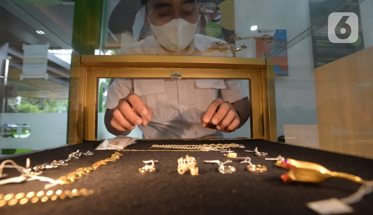 Petugas pegadaian memperlihatkan lelang emas perhiasan di kantor pusat Pegadaian, Jakarta, Selasa (20/4/2021). PT Pegadaian (Persero) terus berupaya memberikan pelayanan kepada masyarakat Indonesia. (merdeka.com/Imam Buhori)