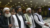 Mullah Abdul Ghani Baradar, pemimpin tertinggi kelompok Taliban (kiri kedua) tiba dengan anggota delegasi Taliban lainnya untuk mengadakan pembicaraan di Moskow, Rusia. (Foto: AP / Alexander Zemlianichenko)
