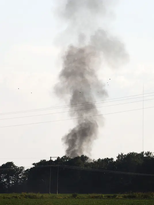 Kepulan asap mengudara dari lokasi jatuhnya sebuah pesawat militer milik AS di wilayah Sunflower-Leflore, Mississippi, Senin (10/7). Pesawat militer yang mengalami kecelakaan diketahui berjenis C-130 Hercules milik Korps Marinir AS (AP Photo/Andy Lo)