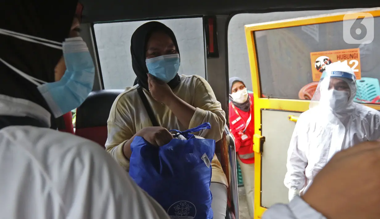 Warga berada di dalam mobil saat akan dibawa ke wisma atlet di Jalan As-Syafiiyah, Cipayung, Jakarta, Jumat (21/5/2021). Klaster Halal Bihalal di Cipayung bertambah 32 orang dari 51 orang menjadi 83 orang terpapar COVID-19 perhari ini. (Liputan6.com/Herman Zakharia)