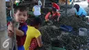Seorang bocah terlihat berada di tempat pengupasan kulit kerang di pemukiman nelayan, Jakarta, Rabu (19/8). Meski berada di Ibukota, para pekerja ini hanya diupah 30 ribu perhari. (Liputan6.com/Angga Yuniar)