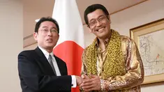 Komedian Jepang Pikotaro berjabat tangan dengan Menteri Luar Negeri Jepang Fumio Kishida di Kementerian, Tokyo, Rabu (12/7). Pikotaro diundang untuk mendampingi Menlu ke pertemuan PBB di markas besar, New York. (AP/ Eugene Hoshiko)