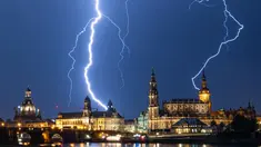 Sambaran petir selama badai terlihat di langit di atas Dresden, Jerman (10/6/2019). (AFP Photo/dpa/Germany Out/Robert Michael)