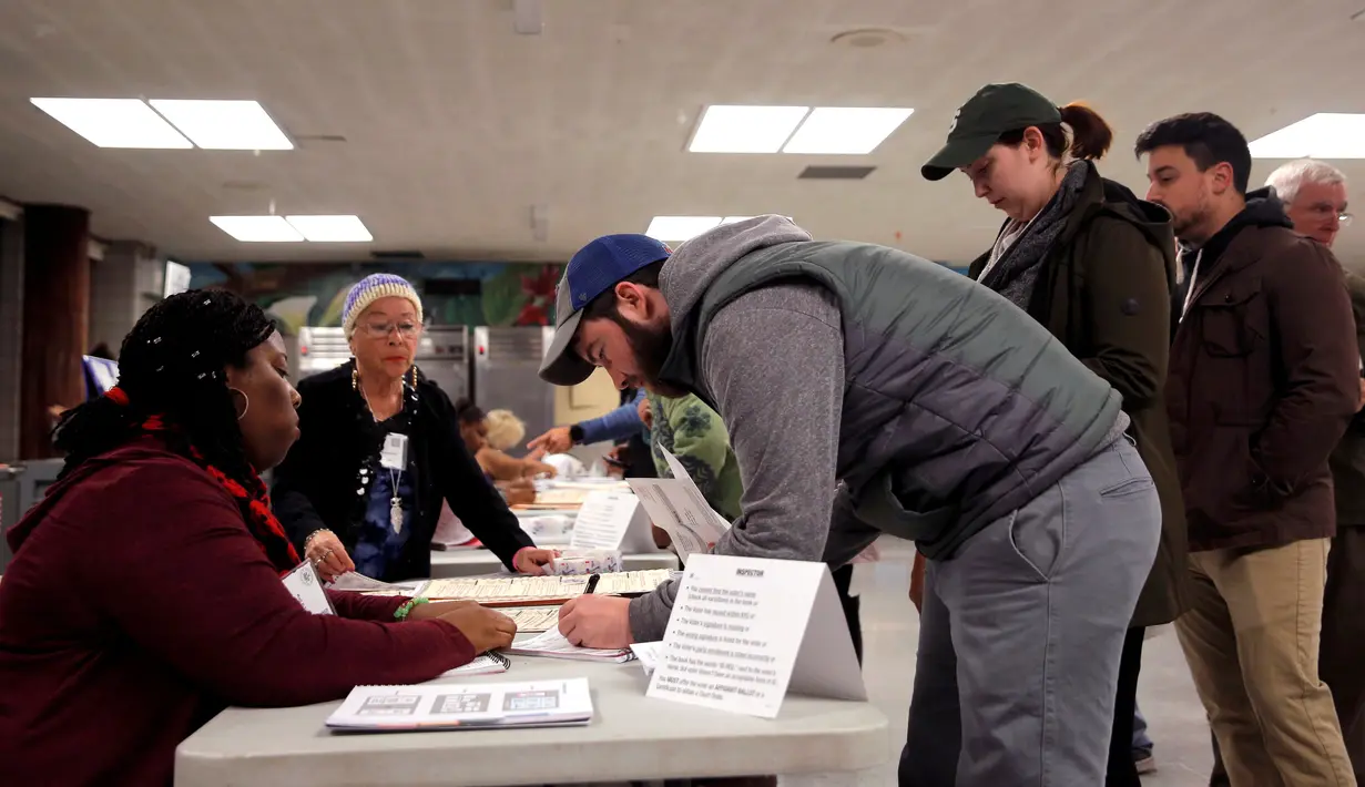 Seorang pria melakukan registrasi untuk pemilihan presiden AS di sekolah James Weldon Johnson di kawasan East Harlem dari Manhattan, New York City, AS, Selasa (8/11). (REUTERS / Andrew Kelly)