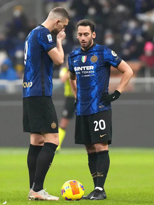 Pemain Inter Milan Edin Dzeko (kiri) dan Hakan Calhanoglu berbicara saat melawan Venezia pada pertandingan sepak bola Liga Italia di Stadion San Siro, Milan, Italia, 22 Januari 2022. Inter Milan menang 2-1. (AP Photo/Luca Bruno)