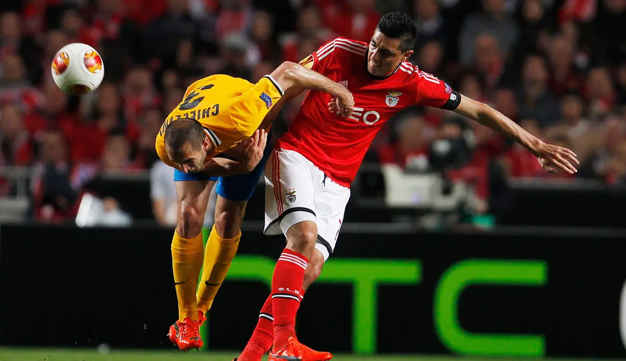 Pemain belakang Juventus, Giorgio Chiellini (kiri) terjatuh saat menahan laju penyerang Benfica, Oscar Cardozo pada laga pertama semifinal Liga Europa di stadion Luz, Lisbon (25/4/2014). (REUTERS/Rafael Marchante)