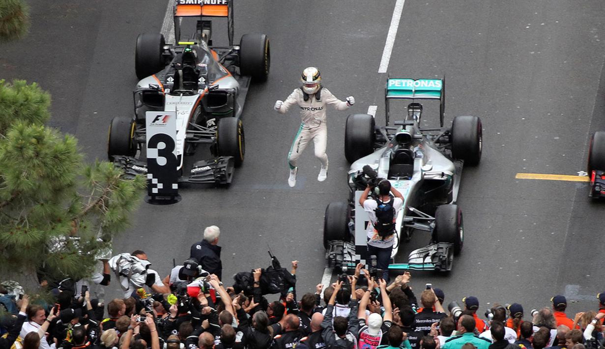 Ekspresi kegembiraan pebalap Mercedes, Lewis Hamilton, setelah menjadi juara F1 GP Monako di Sirkuit Monako, Minggu (29/5/2016). (AFP/Valery Hache)