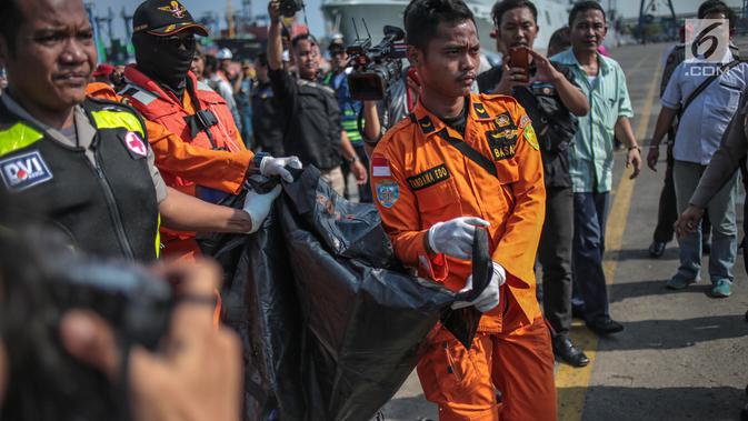 Petugas Basarnas membawa kantung jenazah terkait jatuhnya pesawat Lion Air JT 610 di Posko Evakuasi, Tanjung Priok, Jakarta, Senin (29/10). Pesawat membawa 178 penumpang dewasa, 1 anak-anak, 2 bayi, dan 7 awak pesawat. (Liputan6.com/Faizal Fanani)