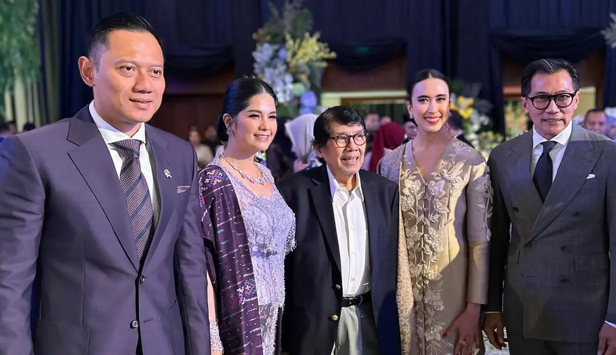 Annisa Pohan tampil serba ungu dengan kebaya kutubaru modifikasi dan kain ulos. Dipadu dengan open toe heels hitam dan tas Chanel berwarna ungu gelap [@widi.wardhana]