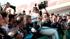 Pembalap Mercedes, Lewis Hamilton berselebrasi bersama timnya saat merayakan keberhasilnnya menjuarai GP Hungaria di Sirkuit Hungaroring, Mogyorod, (29/7). Hamilton berhasil menjuarai secara beruntun di musim ini. (AP Photo/Laszlo Balogh)