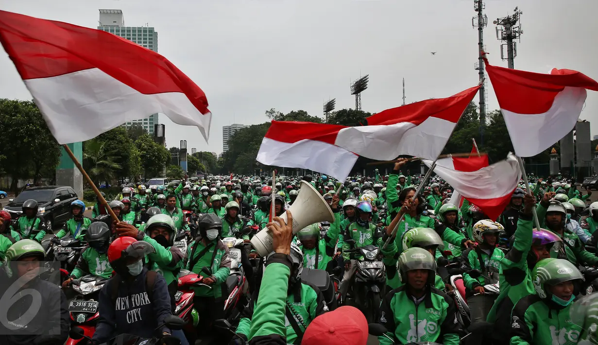 Massa driver Gojek berkumpul di jalan Asia Afrika, Jakarta, untuk selanjutnya menggelar unjuk rasa ke kantor pusat mereka di Kemang, Senin (3/10). Ratusan pengemudi Gojek itu menuntut penghapusan sistem performa atau rating. (Liputan6.com/Johan Tallo)