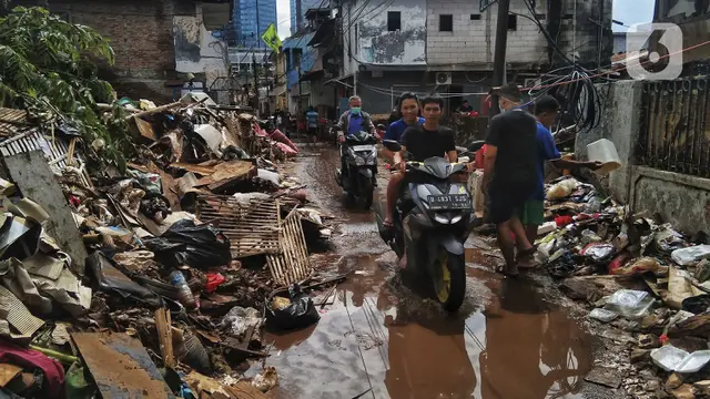 FOTO: Warga Bersihkan Sisa Banjir di Kebalen