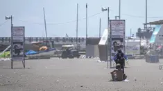 Seorang petugas polisi meminta seorang pria untuk menjauh dari sebuah pantai yang kosong karena adanya peringatan tsunami di kota Fujisawa, prefektur Kanagawa pada tanggal 30 Juli 2025. (Yuichi YAMAZAKI/AFP)