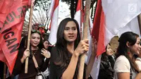 Sejumlah wanita membawa bendera saat memeriahkan arak-arakan PDIP menuju Kantor KPU, Jakarta, Selasa (17/7). Kedatangan anggota PDIP untuk mendaftarkan bakal caleg di KPU diiringi pawai bendera, ondel-ondel, musik. (Merdeka.com/Iqbal S. Nugroho)