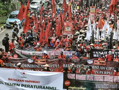 Massa buruh dan tani saat menggelar longmarch menuju Istana Negara di Jalan Salemba Raya, Jakarta, Selasa (20/10/2020). Ratusan buruh dan tani dari berbagai daerah tersebut akan menggelar aksi di Istana Negara menolak UU Omnibus Law Cipta Kerja. (merdeka.com/Iqbal S. Nugroho)