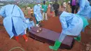 Orang-orang yang mengenakan pakaian pelindung bersiap menurunkan peti jenazah seorang anak berusia enam tahun yang meninggal akibat Ebola, ke dalam liang lahat di Bunia, Provinsi Ituri, Kongo timur, Selasa, 18 Agustus 2026. (Foto AP/Dieudonne Dirole)