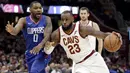 LeBron James (23) menggiring bola melewati adangan pemain Los Angeles Clippers, Sindarius Thornwell (0) pada laga NBA basketball game di Quicken Loans Arena, Cleveland, (18/11/2017), Cavs menang 118-113. (AP/Tony Dejak)