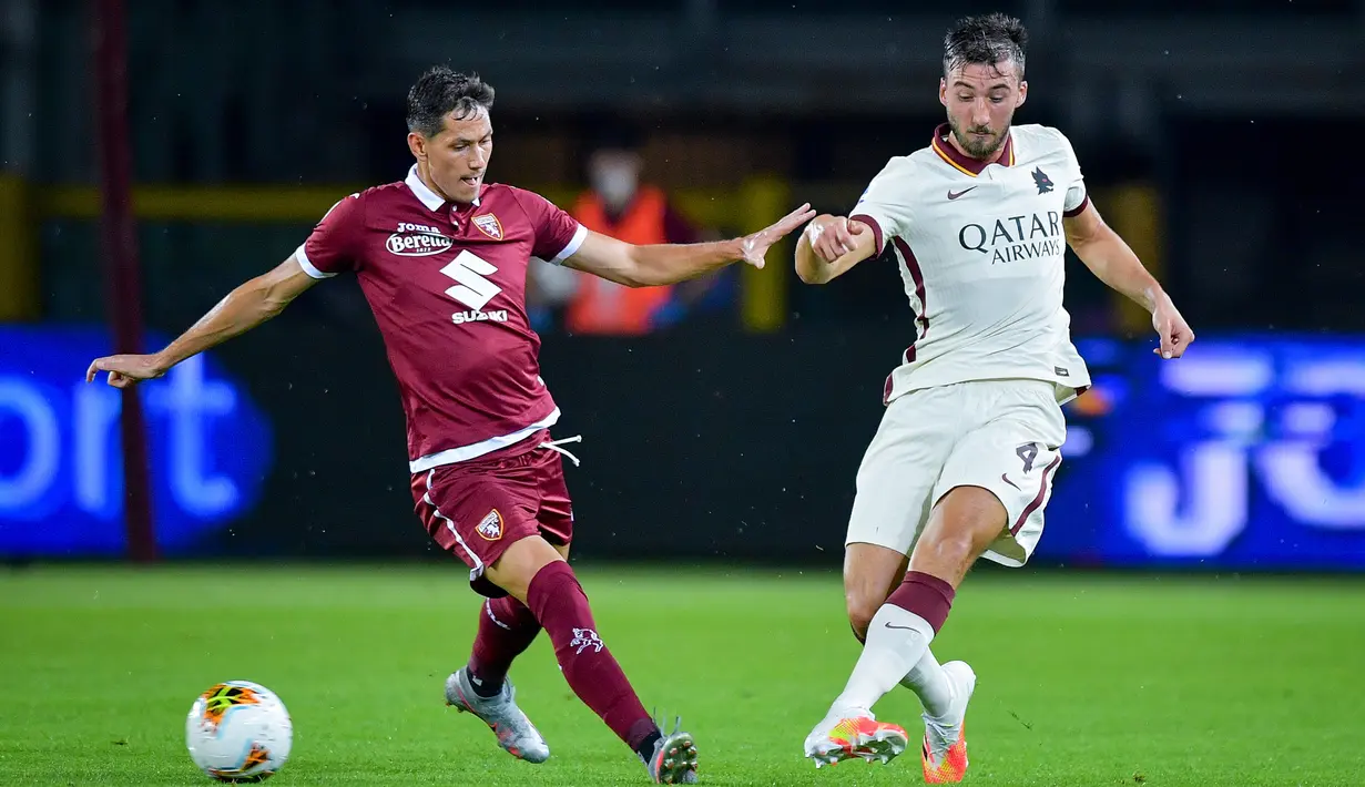 Gelandang AS Roma, Bryan Cristante berebut bola dengan pemain Torino, Alejandro Berenguer pada pekan ke-37 Liga Italia di stadion Grande Torino di Turin, Rabu (29/7/2020). AS Roma berhasil mengalahkan tuan rumah Torino 3-2 meski sempat tertinggal lebih dulu. (Fabio Ferrari/LaPresse via AP)