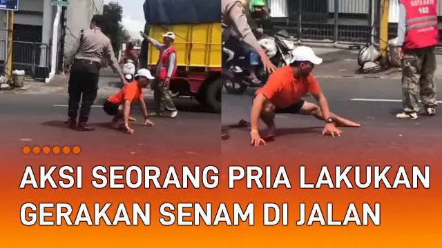 Aksi seorang pria lakukan gerakan senam di tengah jalan mengundang perhatian