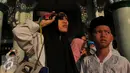 Warga menikmati proses Gerhana Matahari Total (GMT) menggunakan film bekas di halaman masjid Al-azhom Kota Tangerang, Rabu (9/3/2016). Salat gerhana tersebut diadakan sebagai ungkapan syukur atas kuasa Allah SWT. (Liputan6.com/Faisal R Syam)