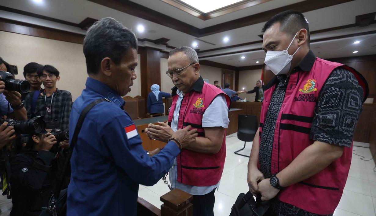 Sebagai informasi, terdapat dua hal yang diduga menjadi pokok permasalahan, yaitu terkait impor produk kilang atau bahan bakar minyak (BBM) serta terkait penjualan solar nonsubsidi. Tampak dalam foto, terdakwa kasus dugaan korupsi tata kelola minyak mentah, Hanung Budya Yuktyanta (tengah) bersama Martin Haendra Nata (kanan) usai mengikuti sidang pembacaan tuntutan di Pengadilan Tindak Pidana Korusi (Tipikor), Jakarta, Kamis (23/4/2026). (Kapanlagi.com/Budy Santoso)