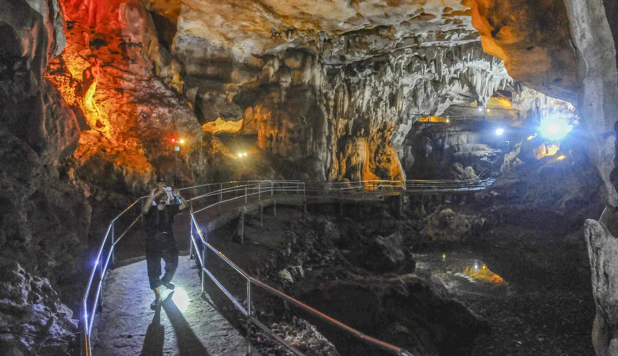 Akses wisata di dalam gua telah dilengkapi jalur khusus dan pencahayaan lampu warna-warni sehingga pengunjung dapat menjelajahi lorong-lorongnya dengan aman dan nyaman. Tampak dalam foto, aktivitas pengunjung di dalam Goa Lowo di Watuagung, Trenggalek, Jawa Timur. (merdeka.com/Arie Basuki)