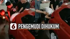 Massa yang terganggu menghukum pengemudi dengan mendekatkan telinga ke knalpot.