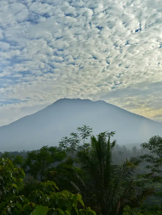 Pemandangan Gunung Agung dari Karangasem di pulau resor Bali, Indonesia (24/9). Letusan gunung Agung terjadi antara tahun 1963 dan 1964 menewaskan lebih dari 1.000 orang dan mencederai ratusan lainnya. (AFP Photo/Sonny Tumbelaka)